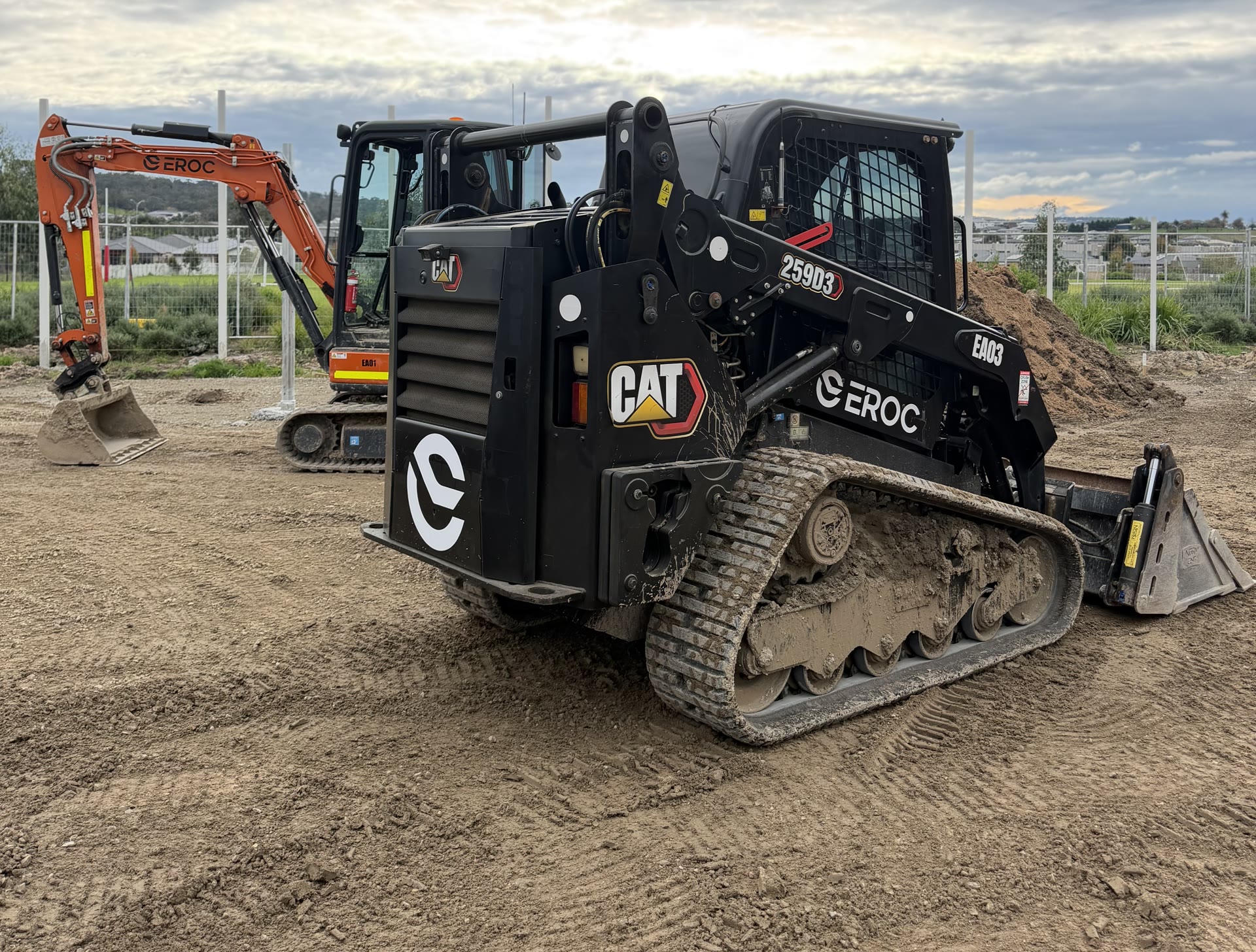 EROC CAT posi-track and excavators lined up on a civil site